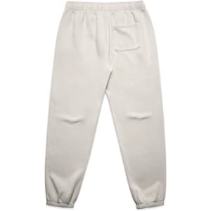 Faded cream track pants with a relaxed fit, featuring an elastic waistband and a back pocket.