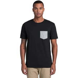 A black t-shirt featuring a grey pocket, suitable for casual wear. The model is standing and looking directly at the camera.