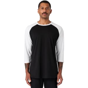 A black and white raglan tee shirt, featuring three-quarter sleeves and a casual fit, worn by a model.