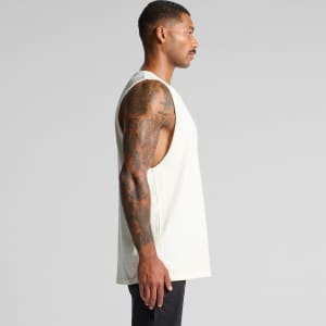 A light-coloured singlet tank top with a loose fit, featuring side cutouts and a logo.