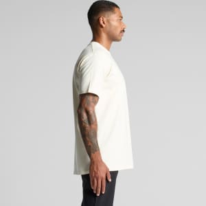 A side view of a light cream short-sleeve classic tee t-shirt with a simple design and a logo.