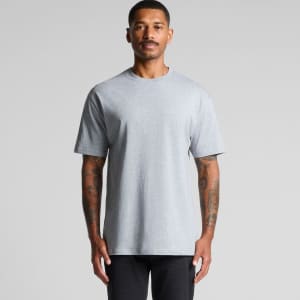 A grey t-shirt featuring short sleeves and a relaxed fit, displayed on a model with tattoos. Includes a logo.