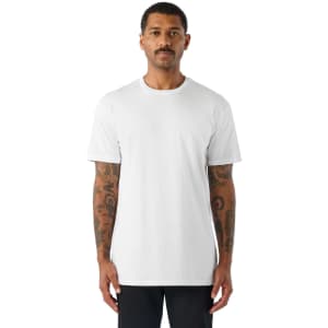 A plain white short-sleeve t-shirt featured on a model with tattoos, standing against a white background.
