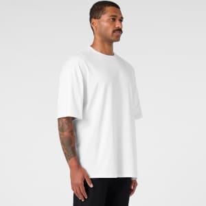 An oversized white t-shirt featured on a model, showcasing a relaxed fit and short sleeves.