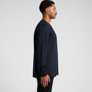 A long-sleeve navy T-shirt worn by a model, featuring a simple design and a logo on the front.