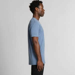 A side view of a blue t-shirt, featuring a simple design and a logo on the front.