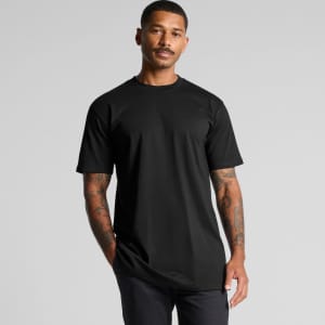 A black Classic Plus Tee with short sleeves, featuring a logo, worn by a man with tattoos.