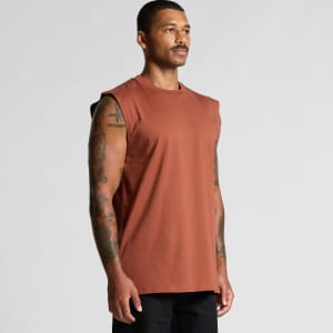 A man displaying a rust-coloured classic tank top with sleeveless design and a subtle logo.