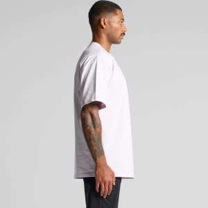 A light pink t-shirt with a loose fit, featuring a logo on one side, displayed from the profile view.