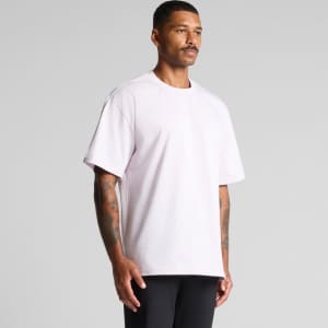 A purple Heavy Tee t-shirt displayed on a model, featuring a relaxed fit and short sleeves.