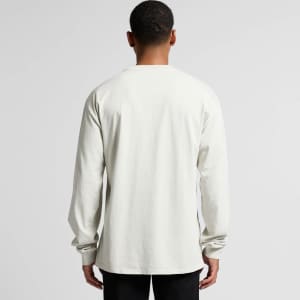A long-sleeve tee in a faded light colour, featuring a plain back and a subtle logo.