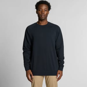 A dark navy jumper featuring a classic crew neck design. The model stands against a neutral background.