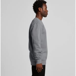 A grey hoodie is displayed on a person facing to the side, featuring a simple design and long sleeves.