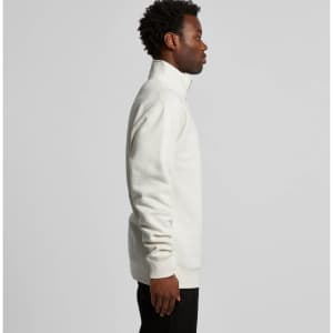 A side view of a cream-coloured half zip crew jumper, featuring a high collar and relaxed fit.