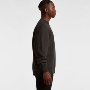 A side view of a black jumper with a crew neckline and long sleeves, featuring a subtle logo.