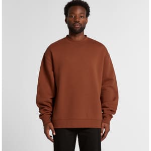 A brown sweater with a relaxed fit, featuring long sleeves and a crew neckline, worn by a model.
