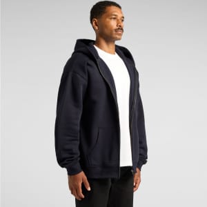 A navy blue hoodie with a zip front, featuring a hood and side pockets, worn by a model.