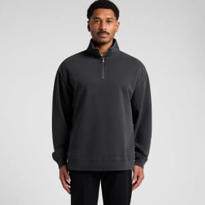 A relaxed half-zip jacket in faded black, featuring a front zipper and a logo detail.