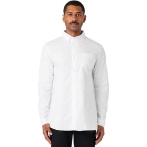 A white button-up Oxford shirt with long sleeves and a chest pocket, featuring a logo.