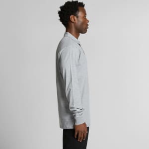 A grey long-sleeve polo shirt with a collar, featuring a branding logo, shown from the side.