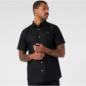A black short-sleeve button-up shirt featuring a front pocket and a logo on the chest.