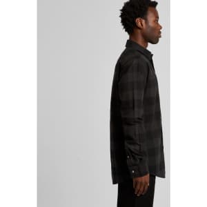 A side view of a black check shirt featuring a collar and button-up front, displayed on a model.