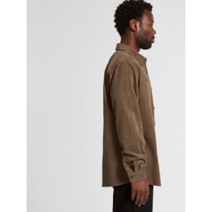 A button-up cord shirt in a warm brown colour, featuring a collar and button detailing, with a side view of a model.