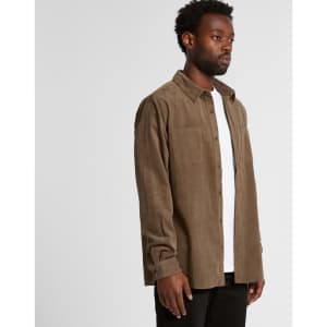 A button-up cord shirt in brown, featuring long sleeves and two chest pockets, worn by a man against a white background.