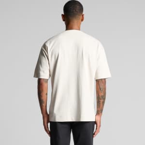 A heavy baseball jersey in cream colour, featuring short sleeves and a plain design. It has a logo on the front.