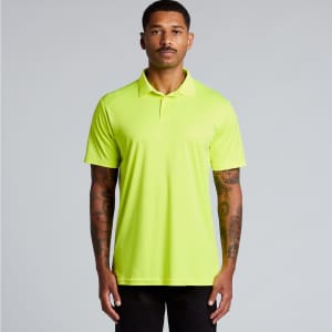 A bright yellow polo shirt features a collar and short sleeves, displayed on a model with tattoos. It has a logo.