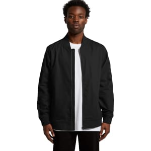 A black bomber jacket is displayed on a model, featuring a zip front and ribbed cuffs. The jacket has a logo.