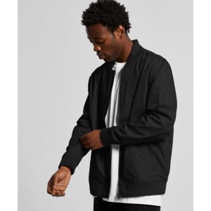 A black bomber jacket with a zip front and ribbed cuffs, worn by a person adjusting the sleeve.