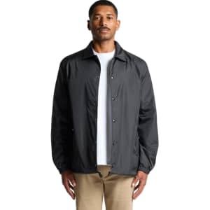 A black coach jacket featuring a button-up front and a relaxed fit, worn by a model.