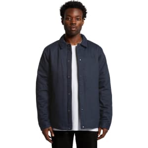 A navy work jacket featuring a button-up front and a collar, worn by a model against a plain background.