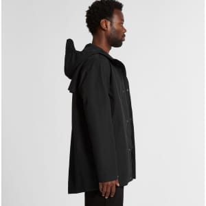 A black rain jacket with a hood, featuring a logo and a loose-fit design, showcased from the side.