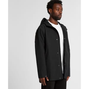 A black rain jacket with a hood, featuring a front zip and snap closures, displayed on a model.