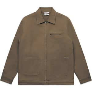 A canvas heavy jacket in olive green with a zip front and two front pockets. It features a small chest pocket and has a logo.