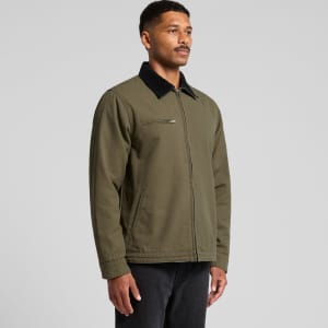 A man wearing an olive green Canvas Cord Collar Jacket with a black collar, featuring a zipped pocket.
