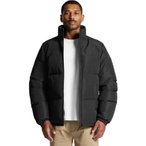 A puffer jacket in black, featuring a high collar and a relaxed fit, displayed on a model.