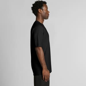 A black t-shirt displayed on a model, showing a side profile view. The shirt features a branding logo.