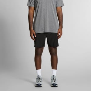 Active shorts in black, featuring a logo, worn with a grey top and light grey sneakers.