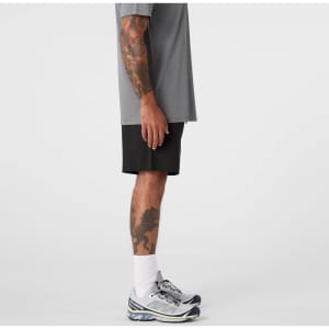 Active Pro Shorts in black, displayed on a person wearing a grey t-shirt and athletic shoes.