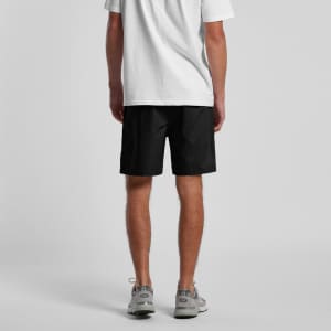 Black beach shorts with an elastic waistband, featuring side pockets and a branding logo.