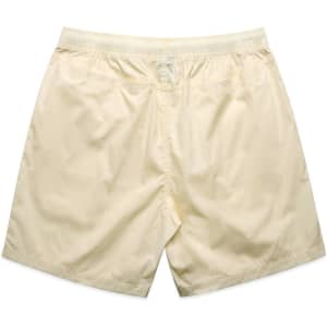 Cream-coloured beach shorts featuring an elastic waistband and a simple design. Includes a logo.