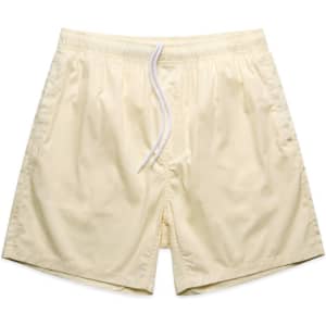 Light yellow beach shorts featuring an elastic waistband and drawstring, with a logo on the side.