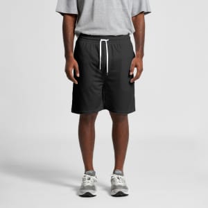 Black sports shorts with a drawstring waist, worn by a person in a grey t-shirt and grey trainers.