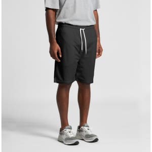 Black sports shorts with an elastic waistband and white drawstring, worn by a person standing.