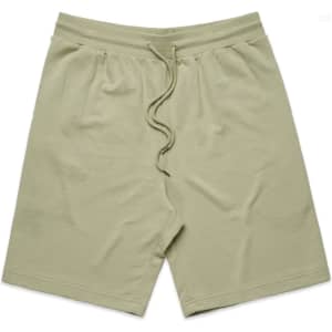 Light green sports shorts with an elastic waistband and drawstring, featuring a logo.