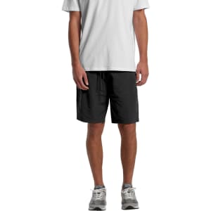 Active training shorts in black, featuring a logo, styled with a grey T-shirt and grey trainers.