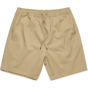 Beige walk shorts with an elastic waistband and drawstring, featuring side pockets and a logo.